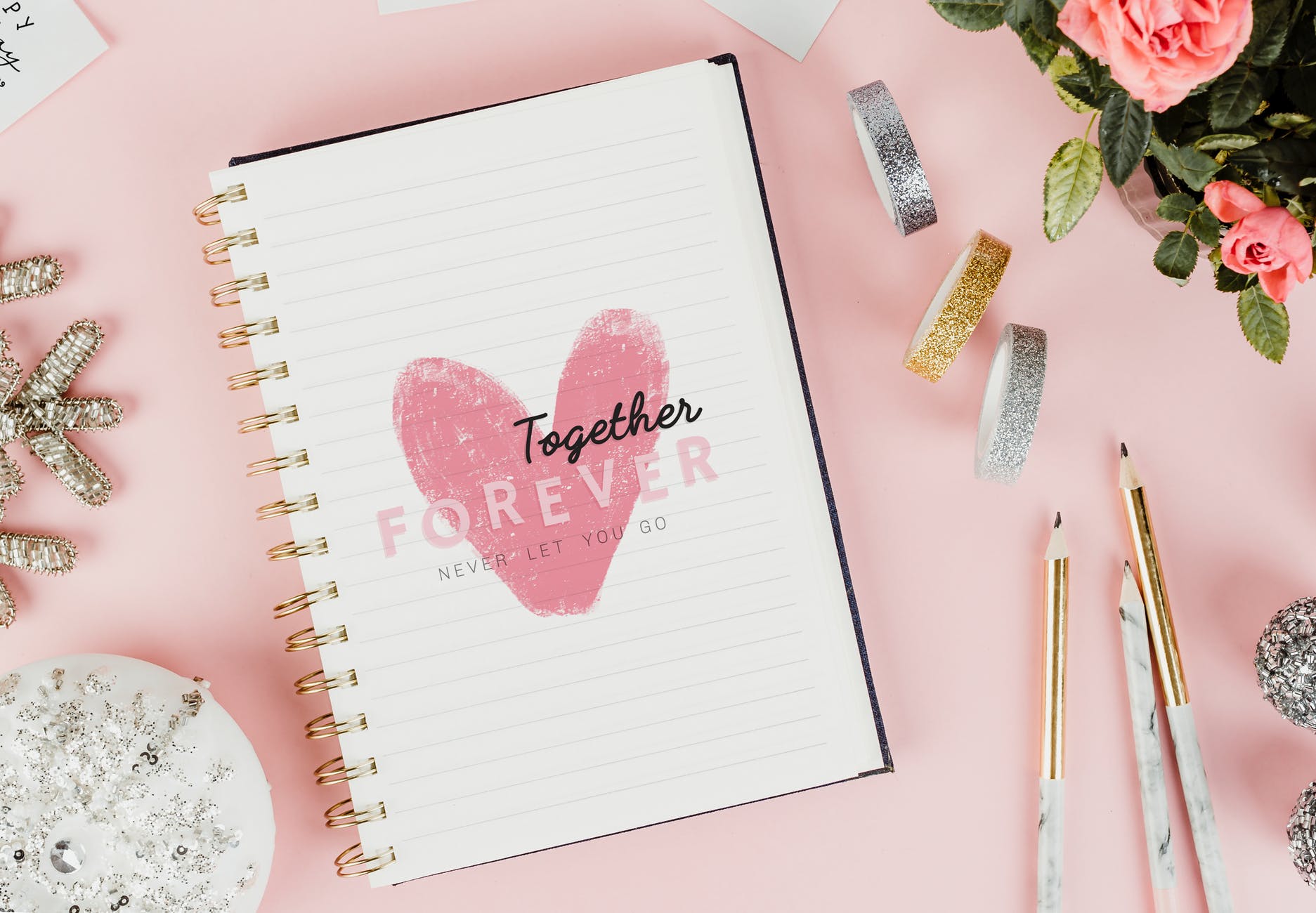 white notebook on pink surface